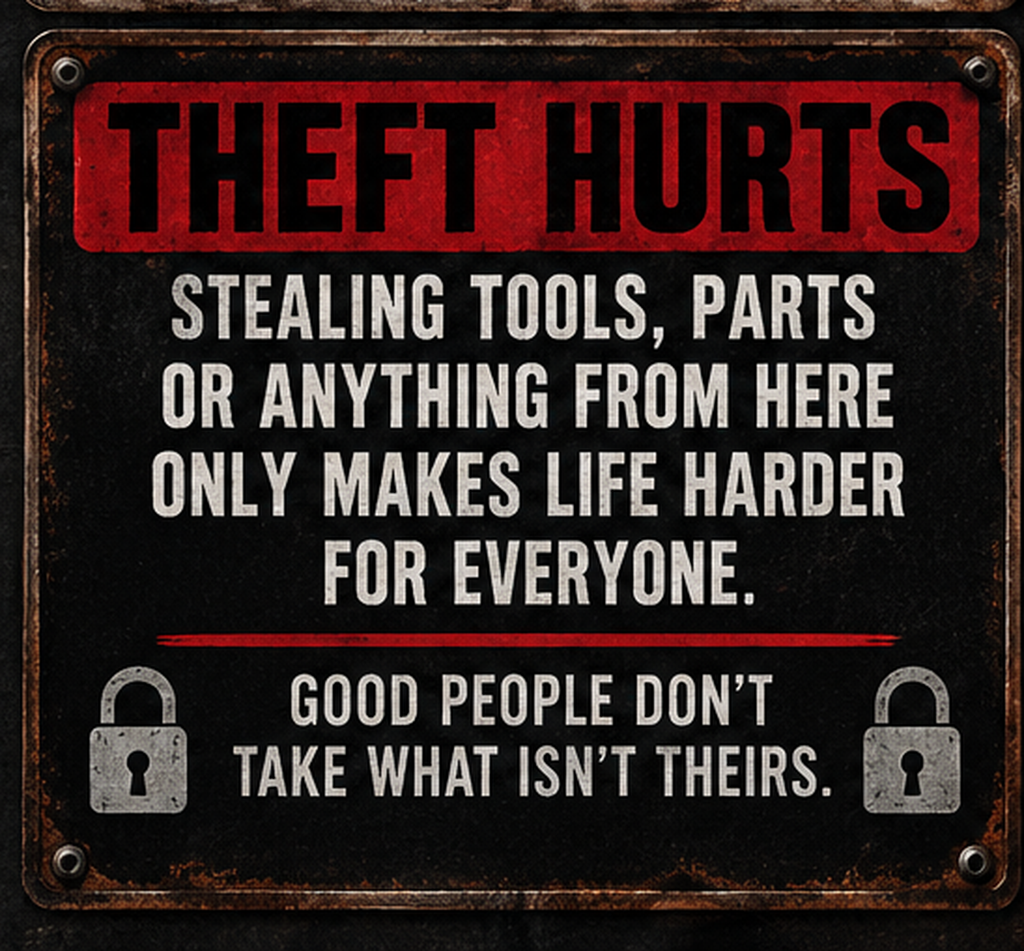 Theft Hurts dark metal garage sign