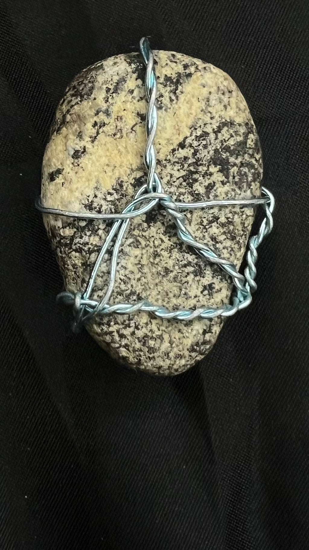 Detail close-up of the actual Dalmatian River Pebble pendant